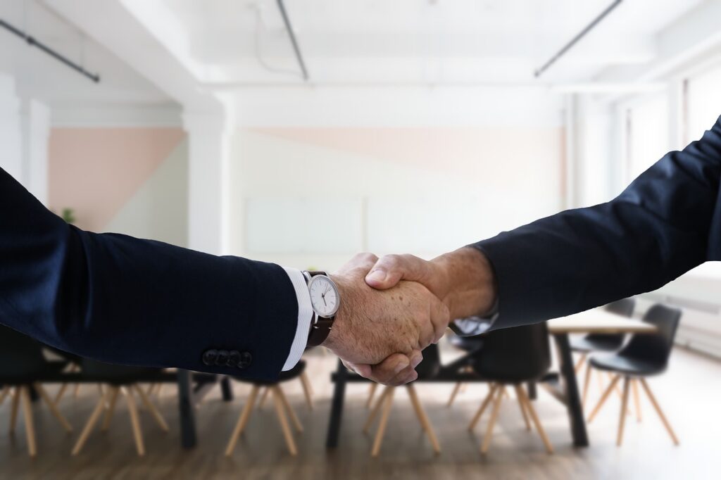 A picture of two people handshaking. 